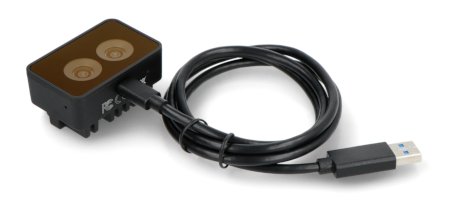 Černé zařízení pro rozpoznávání obrazu Luxonis leží na bílém pozadí s připojeným USB kabelem.